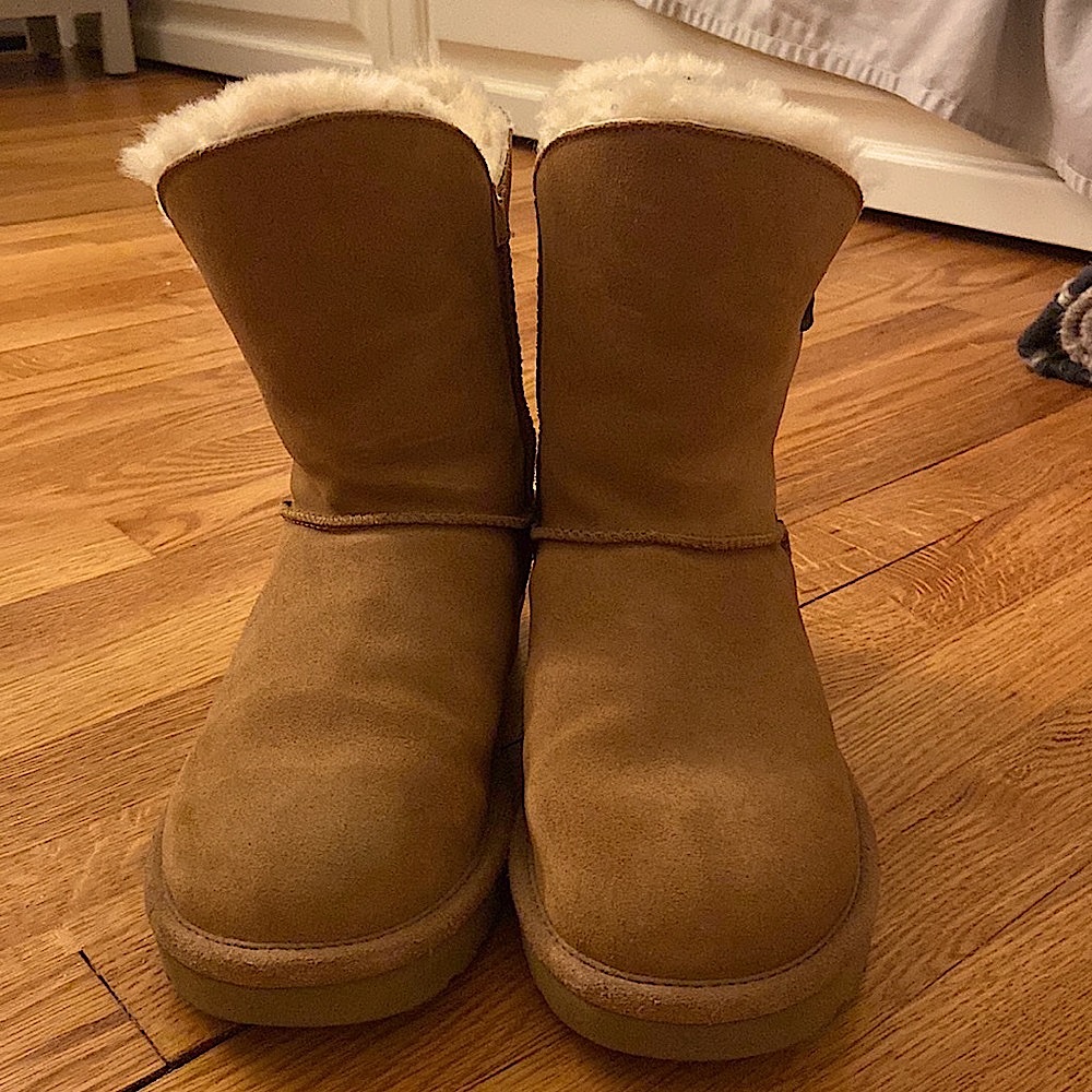 Chestnut Ugg boots with leather strap detail